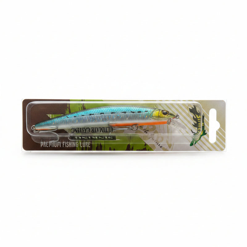 A packaged fishing lure on a gray tiled surface. The lure is a hard bait with a silver and light blue body, orange belly, and yellow details, mounted on a cardboard backing with printed graphics and the text 'PREMIUM FISHING LURE'.